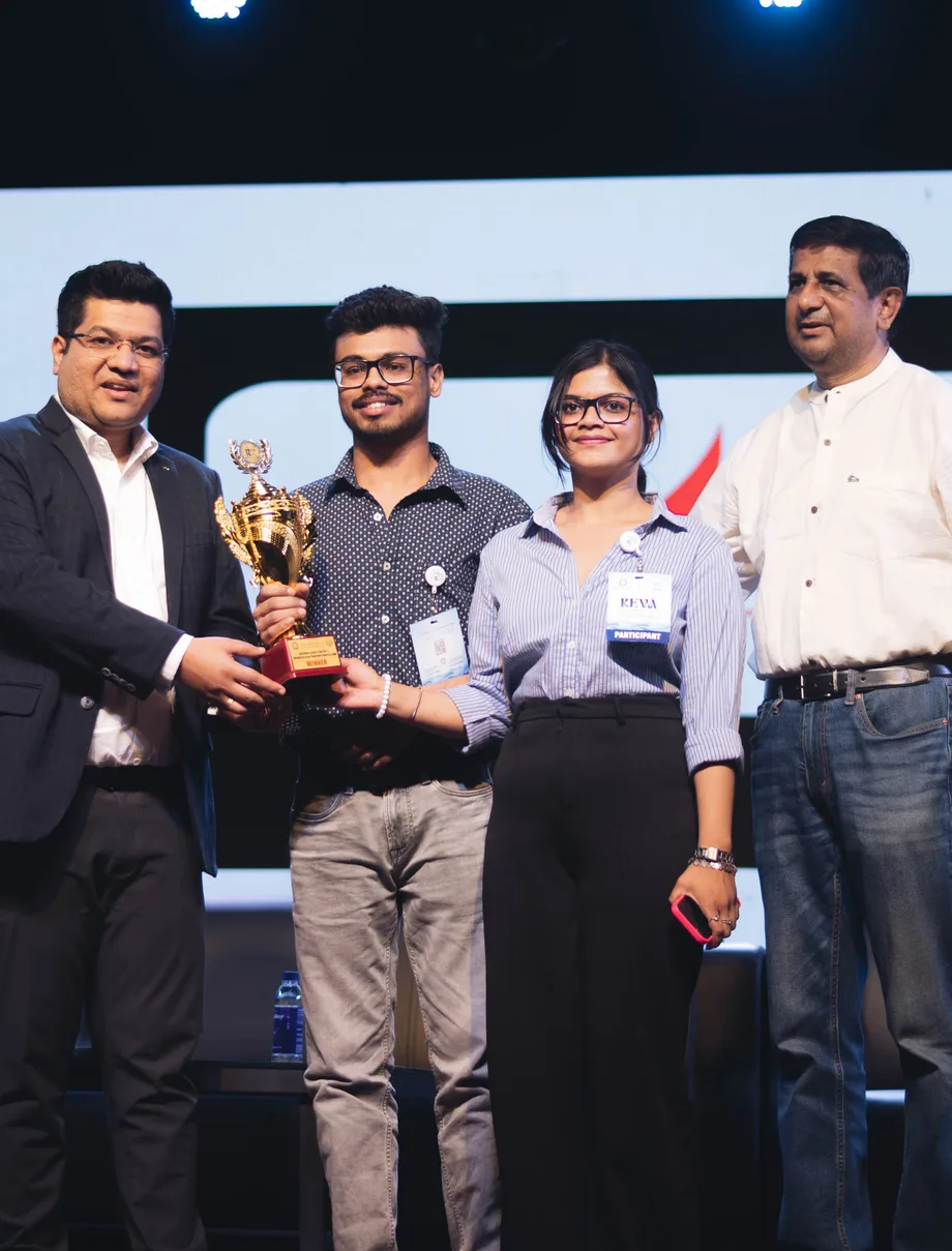 Nowlez co-founders Rithik Chaudhary and Adrika Singh receiving a pitch-competition award on stage